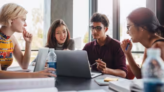 Group of students studying at a library