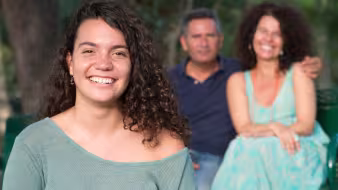 Image of parents posing with daughter