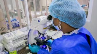 Photo of woman in lab in Abuja, Nigeria testing for COVID-19