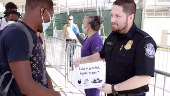 CBP personnel process and screen migrants for possible entry into the U.S.