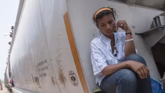 Woman sitting on freight train