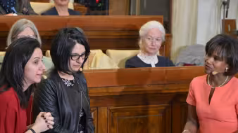 Twin sisters from Syria address a meeting. 