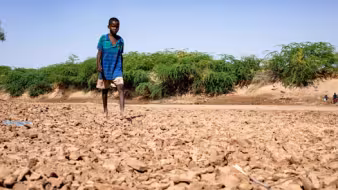Child in dried out Dawa river bed in Somalia during drought