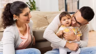 2 parents holding baby