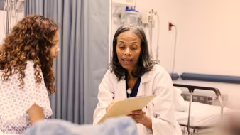 Doctor speaking with patient who is a child 