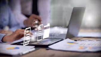 Computer on a table with other digital screens displayed in outline