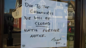 Paper with Closed until further notice in window due to the COVID 19 coronavirus pandemic