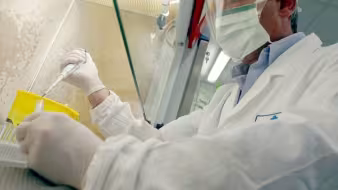 A doctor wearing a face mask performing a test