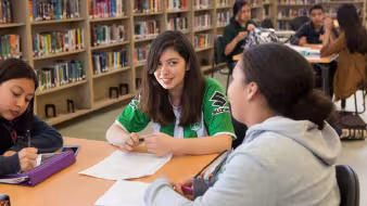 High school students working together in the library
