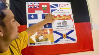 Refugee at an orientation before resettlement to Canada