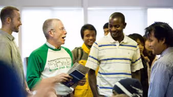 A volunteer and refugees chat at a workshop in Spokane, Washington.