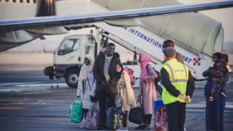 A family of refugees arriving at an airport during resettlement