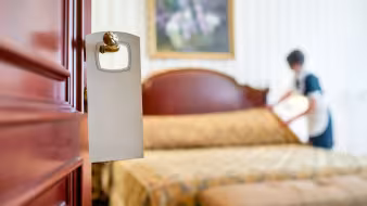Worker cleans hotel room