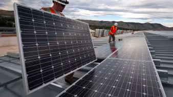 Workers install solar panels