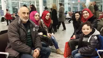 First family of refugees arrives in Toronto.