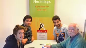 Syrian refugees meet with volunteers at a German for Refugees program.