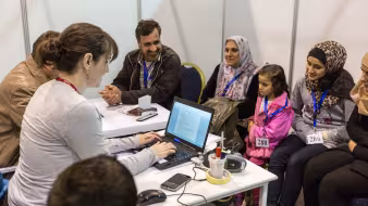 A Syrian family is interviewed by Canadian officials.