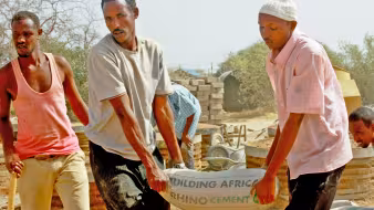 Men building latrines in Dadaab refugee camp in Kenya. 