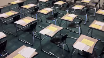 A classroom with exam papers on students' desks