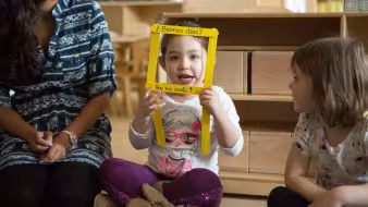 A preschool student shares how she feels during a morning greeting song