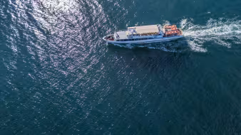 An aerial photo of a small boat at sea