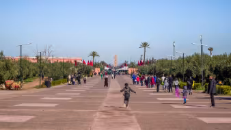 People walk along the road to the Menara Gardens in Marrakech, Morocco