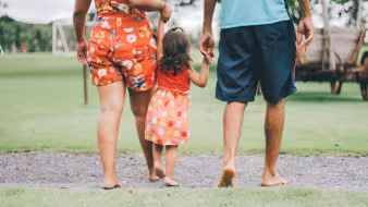 A young child and family walking