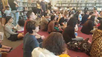 Parents and their children sit in a library for Princeton Children's Book Festival 2018