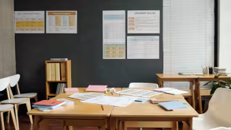 An empty classroom with English language learning posters