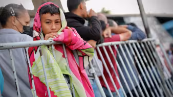 Venezuelans wait in line at the Brazil-Venezuela border