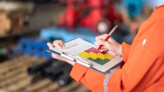 A person holding a clipboard and a pen