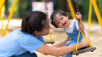 Mother and daughter playing on a playground