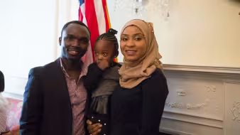 Parents and their young child at a naturalization service.