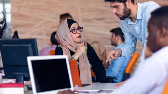 A group of office workers with laptops