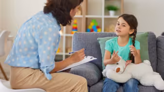 Young girl talks to a child psychologist