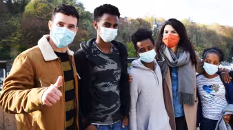 JRS Europe volunteers and young refugees wearing face masks visit a site in Luxembourg