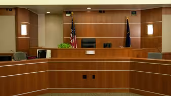 A modern courtroom with the U.S. flag