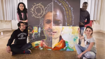 Four refugee artists stand with art they have created that will be shown at the Venice Biennale