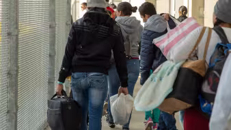 Inadmissible migrants, some seeking asylum, are processed by CBP officers