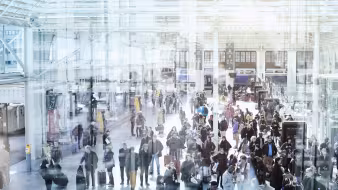People with luggage moving through a French train station