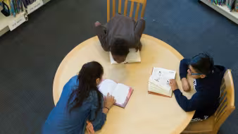 Middle school students studying in a library