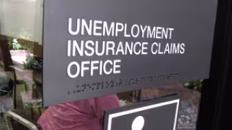 Sign on the window of an unemployment insurance claims office