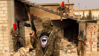 Three men pose with guns