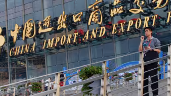 Image of man on steps in front of China Import and Export Fair in Guangzhou, China