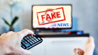 A television with the words "Fake News."