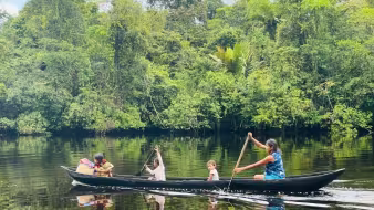 Image of indigenous Warao in a canoe on the Kaituma River in Guyana