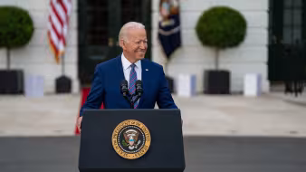 Photo of U.S. President Joe Biden delivering remarks in front of White House.