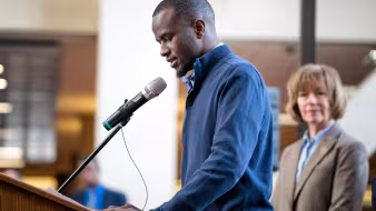 Image of aspiring pastor and DACA recipient speaking at DACA event in Minneapolis