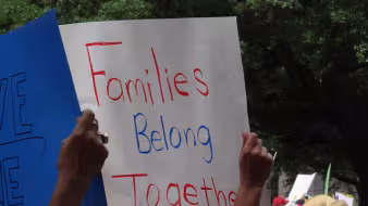 Image of families belong together event banner in Houston
