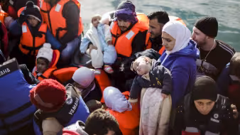 Migrants arrive in Greece on a crowded boat from Turkey.